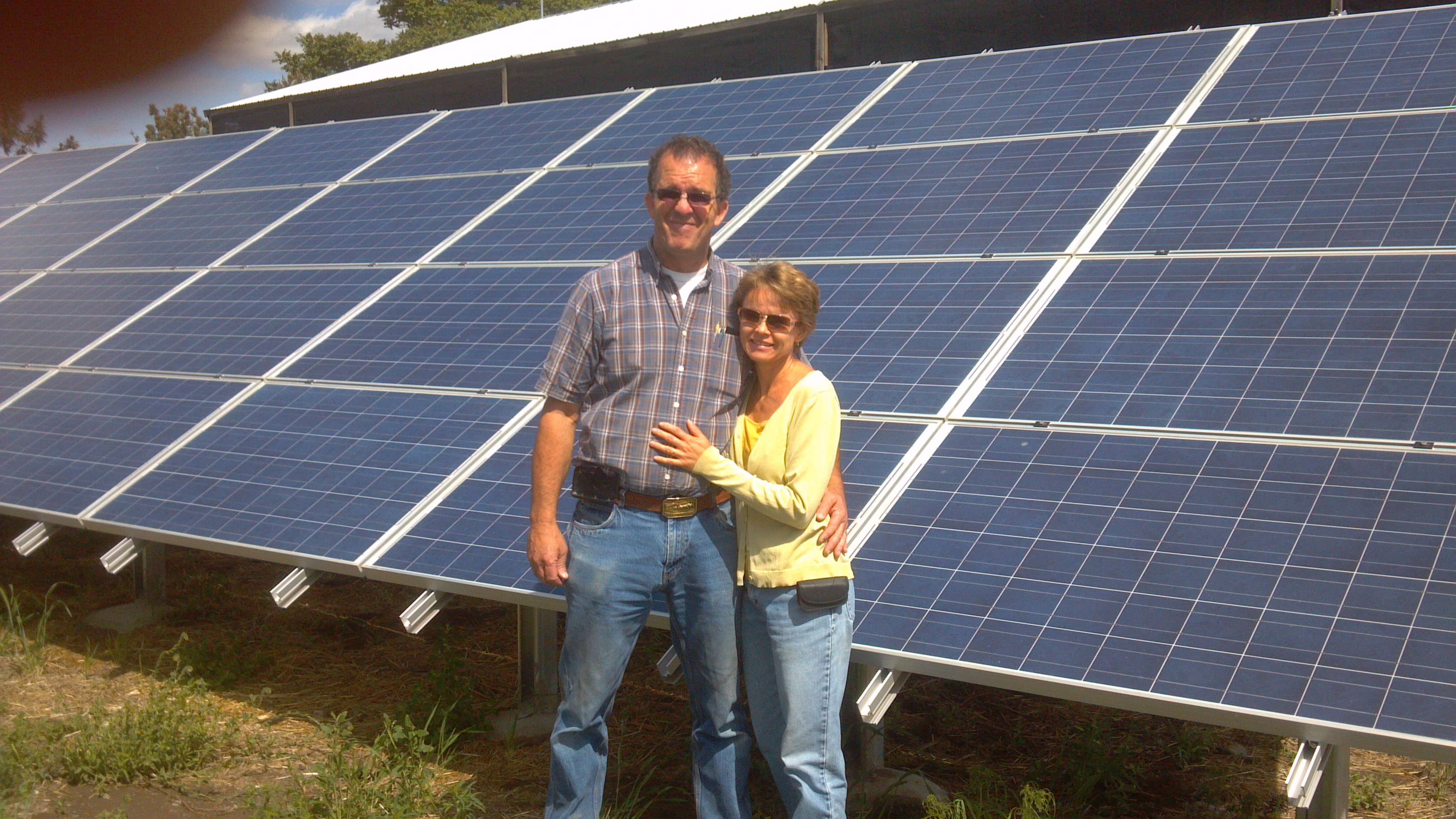 Owners in front of the 360Kw array.